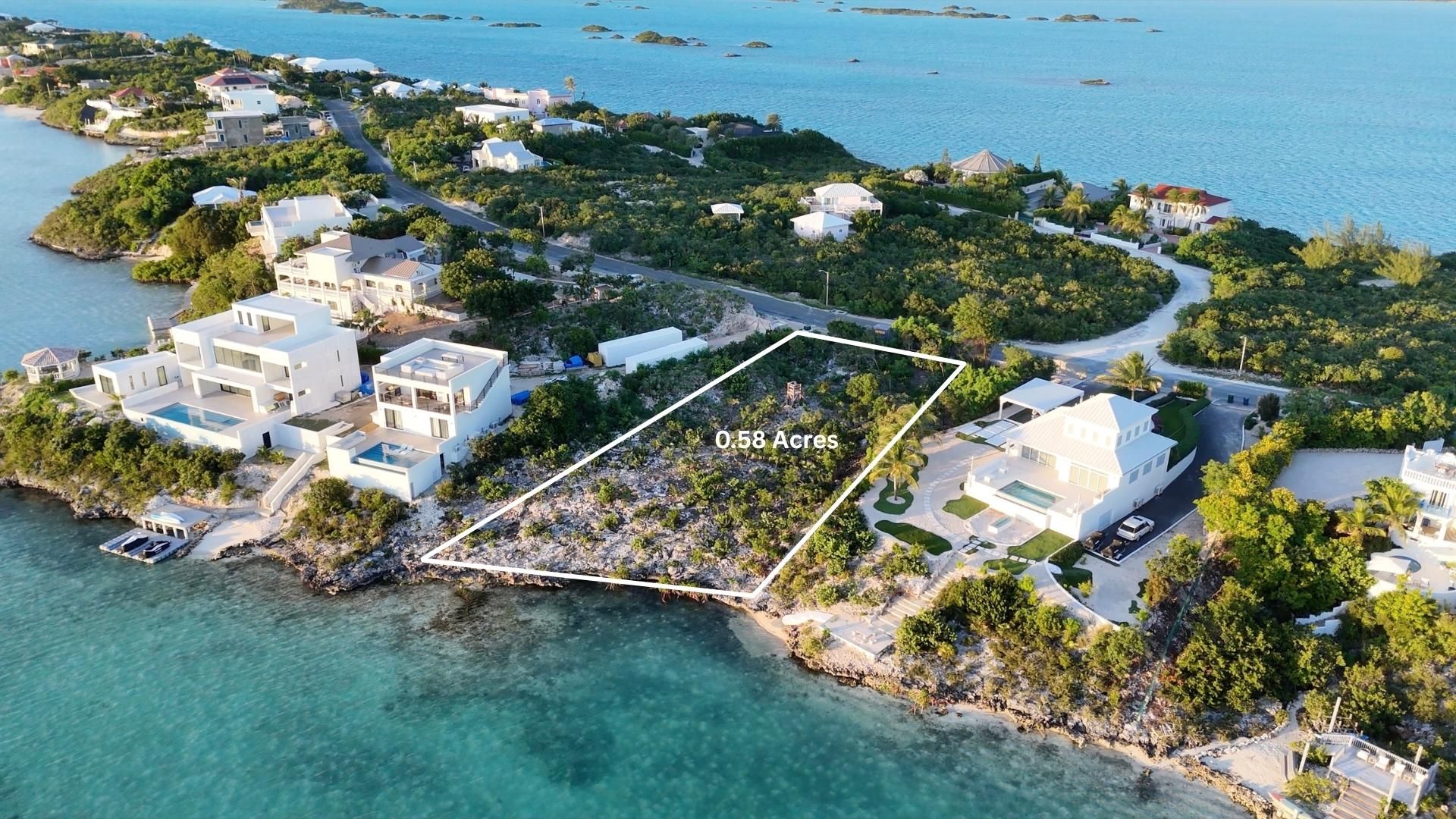The 0.58 acre parcel outlined between completed villas on the Silly Creek shoreline