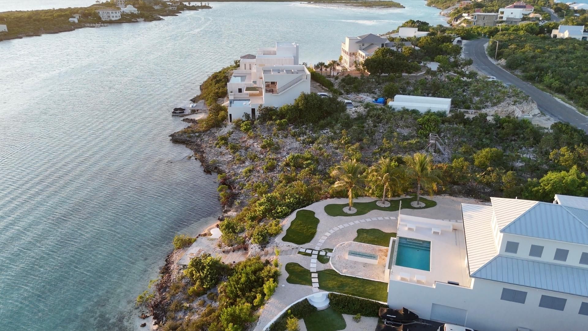 A completed luxury villa with pool on the neighbouring shoreline